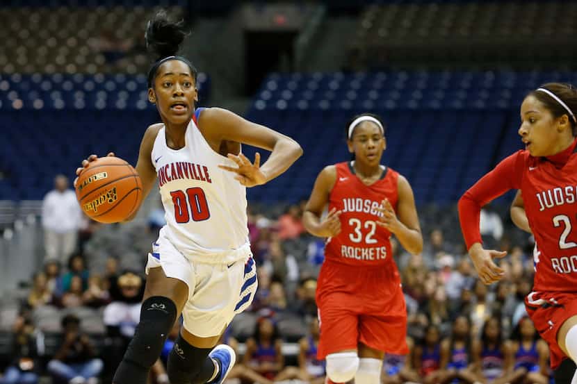 Duncanville's Zarielle Green (00) drives past Converse Judson's Desiree Lewis (32) and Mia...