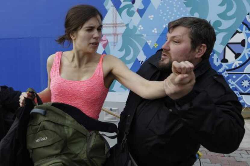 
A Russian security officer attacks Nadezhda Tolokonnikova and a photographer as she and...