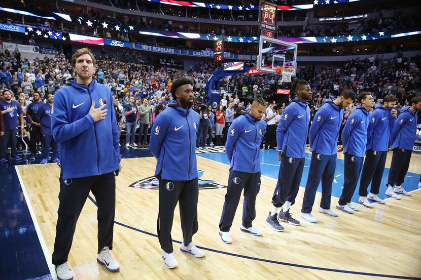 Dallas Mavericks forward Dirk Nowitzki (41) stands with teammates for the United States...