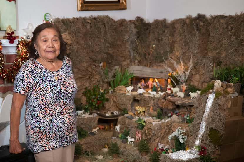 Carmen Meza of Dallas with her Nativity scene in her home in Oak Cliff. 
