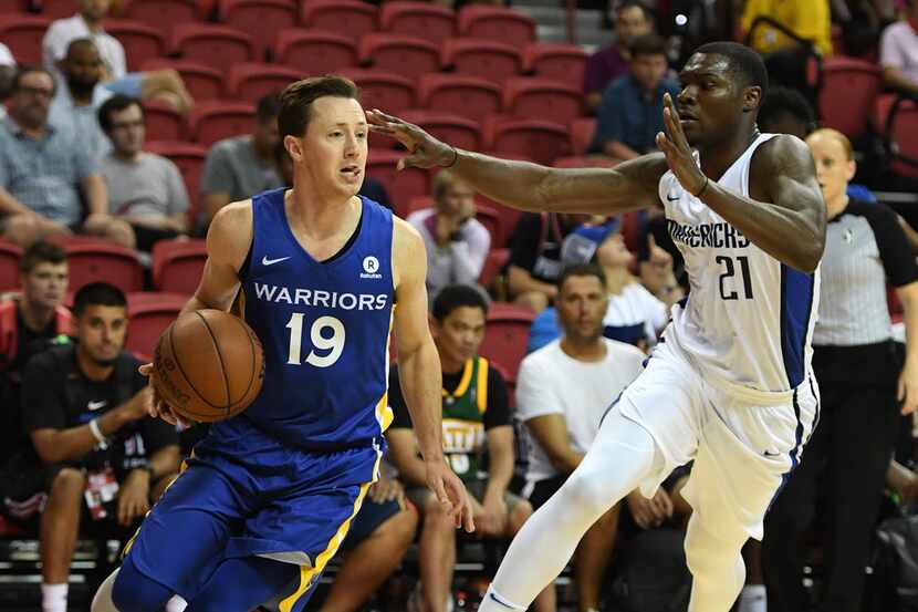 Josh Magette of the Golden State Warriors drives against Jalen Jones (right) of the Dallas...
