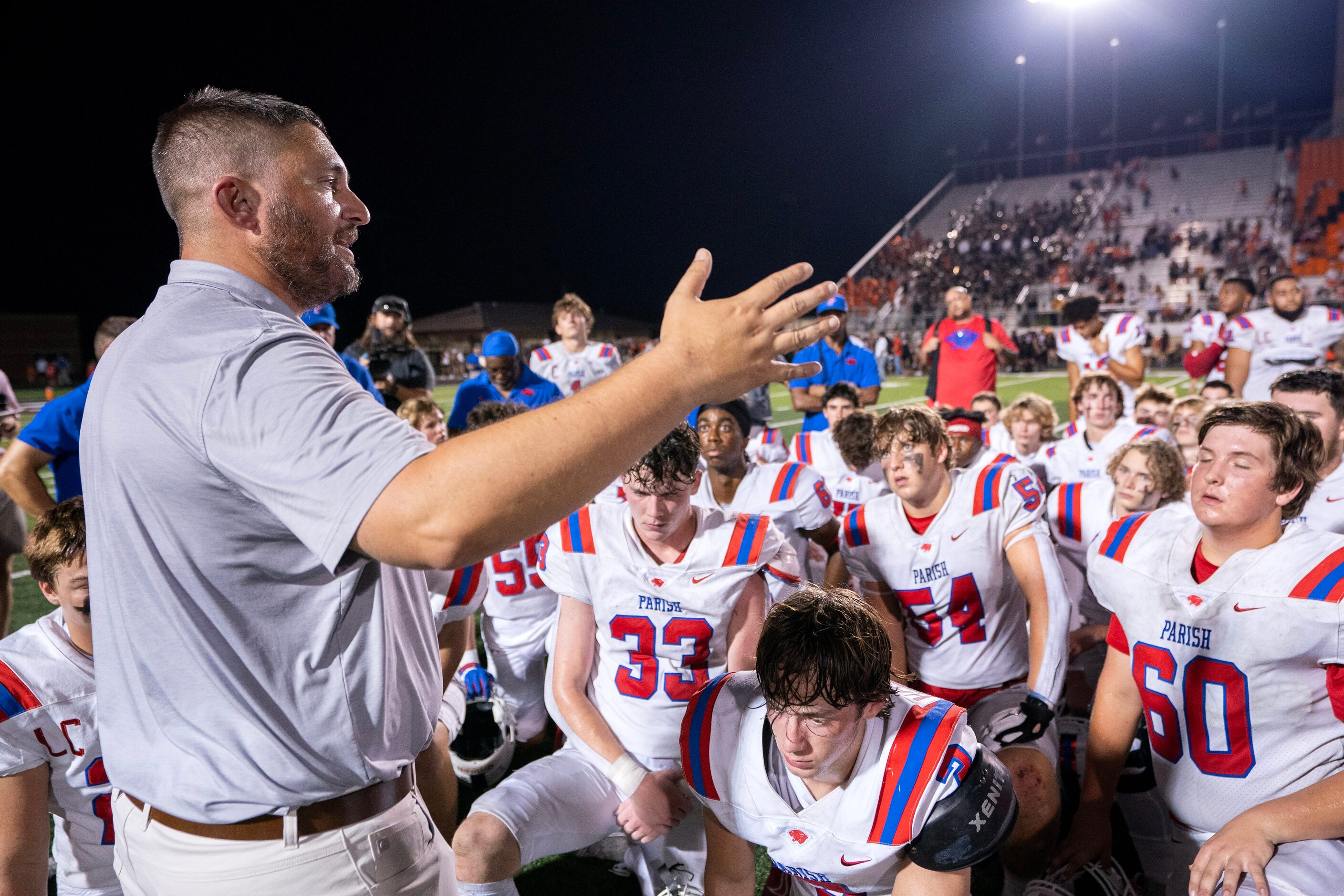 Parish Episcopal head coach Daniel Novakov talks to his team after a 50-35 loss to Aledo in...