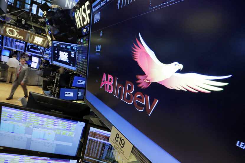The symbol for AB InBev appears at the post where it trades, on the floor of the New York...