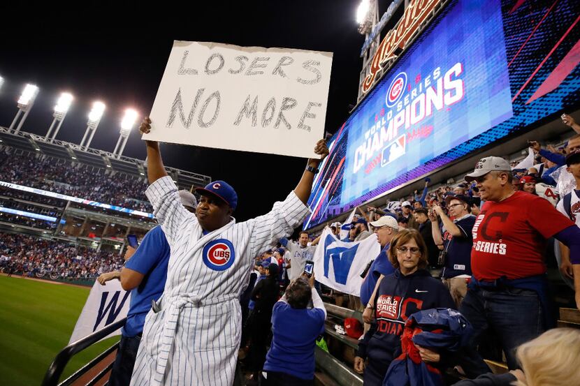 A Chicago Cubs fan holds a sign after the Cubs defeated the Cleveland Indians 8-7 in Game 7...