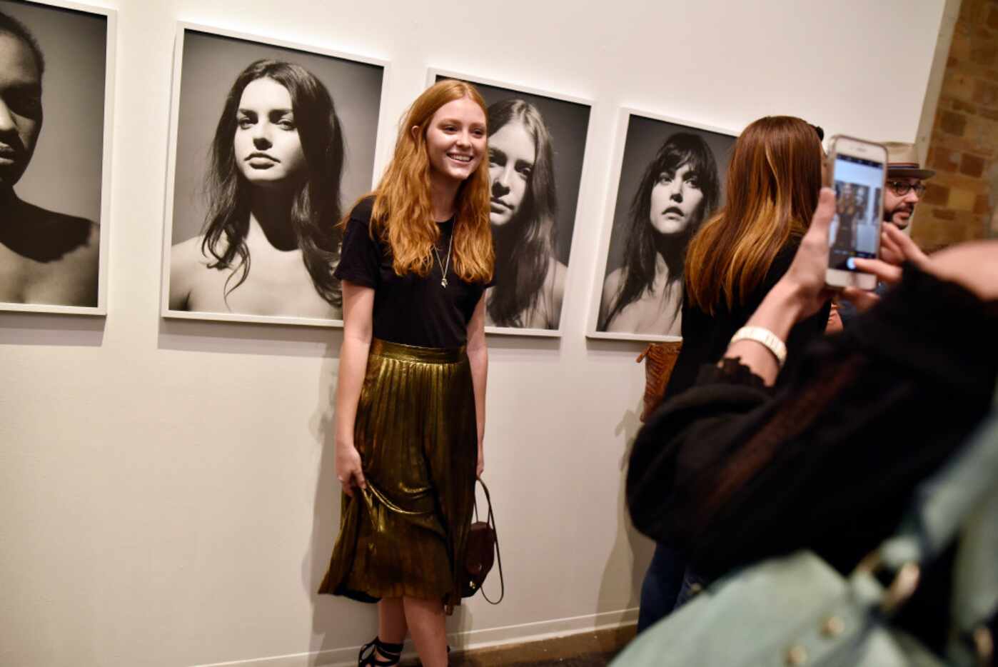 Model Haley Halter is photographed by her mother Laurel Halter next to her image by Fredrik...
