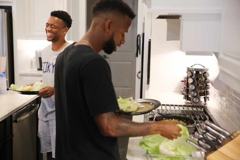 FC Dallas teammate Jacori Hayes (left) laughs while Kellyn Acosta (right) prepares lunch in...