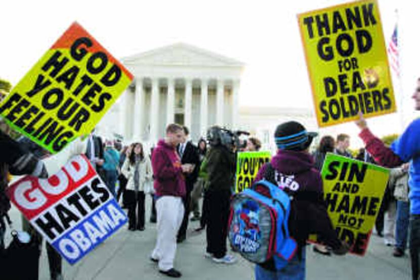  Westboro Baptist Church members picket in front of the Supreme Court, where justices are...