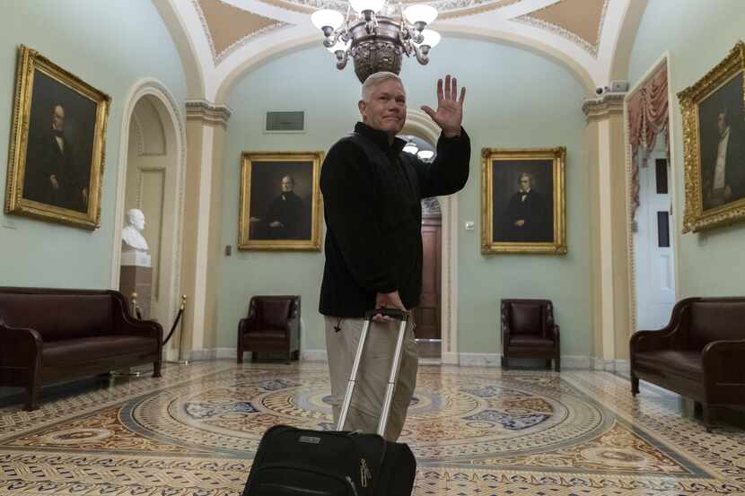 Rep. Pete Sessions, R-Dallas, waved to reporters as he departed the U.S. Capitol on Dec. 22,...