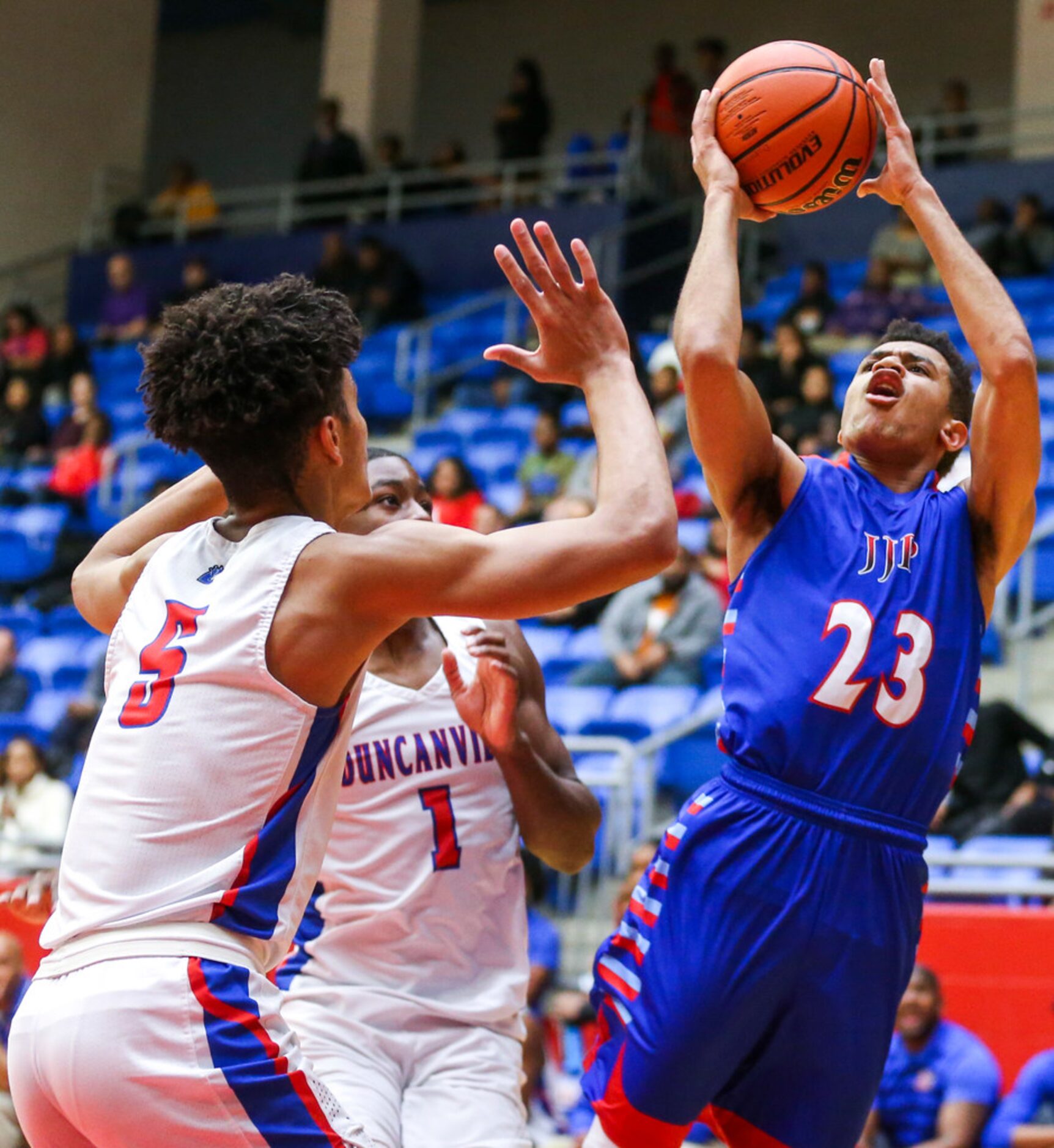 J. J. Pearce guard Sterling Hopkins (23) shoots as he is defended Duncanville guard Micah...