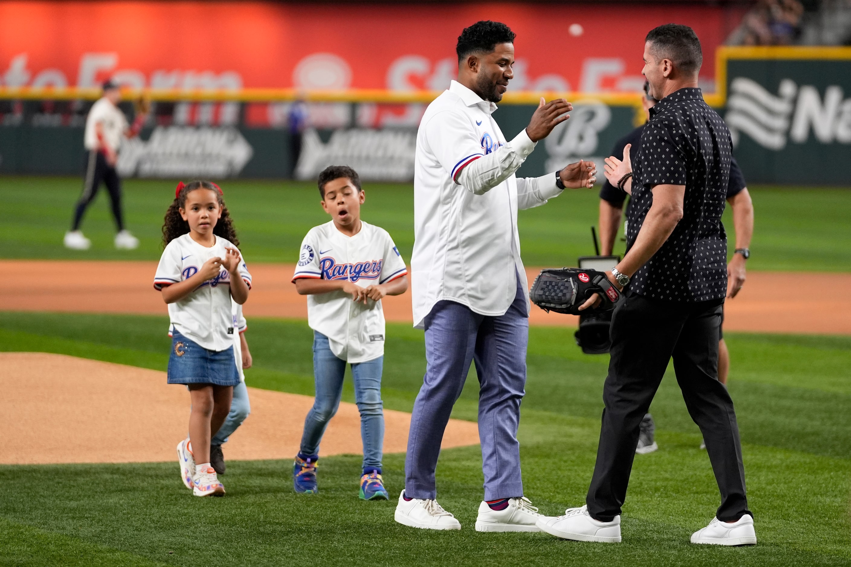 Former Texas Rangers player Elvis Andrus, left, who is followed by his daughter Lucia, left,...