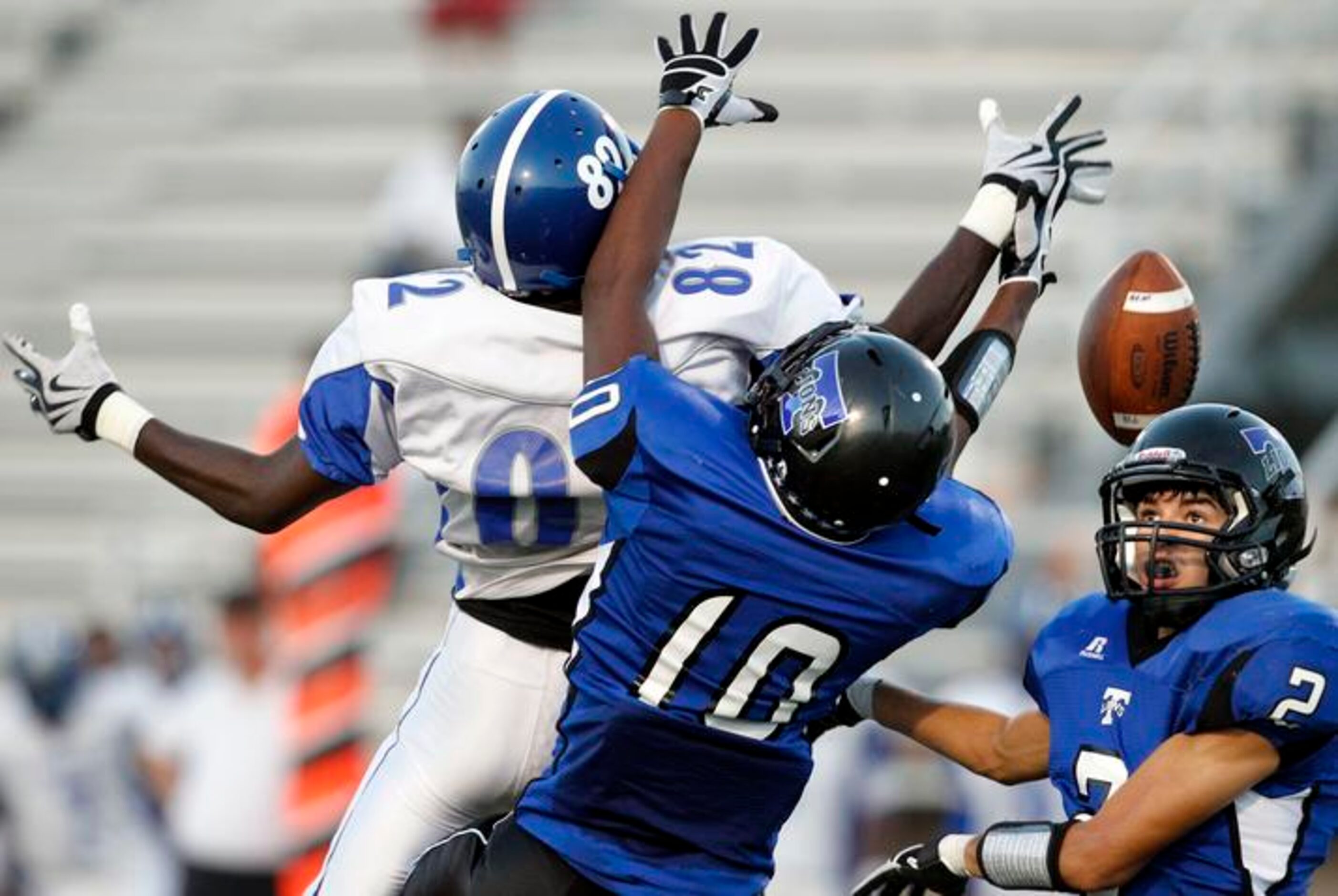 A. Maceo Smith's Justin Carey (82, left) can't hold onto a pass, as Brandon Moore (10,...