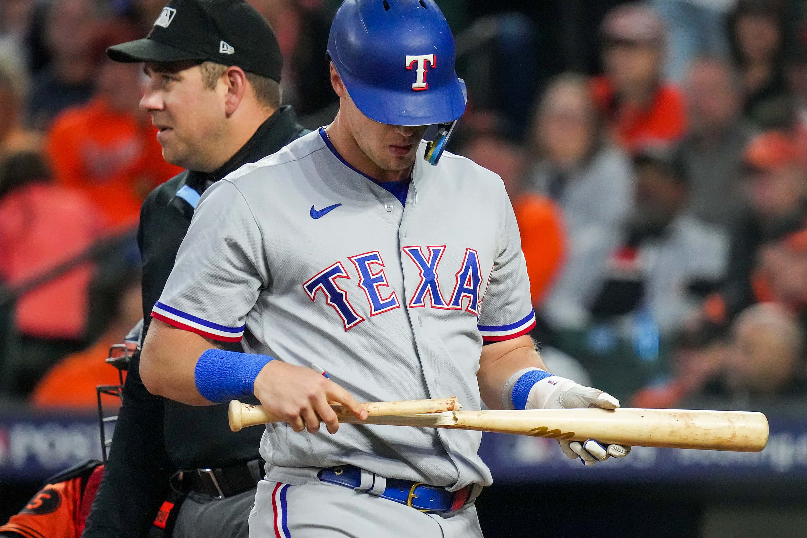 Texas Rangers third baseman Josh Jung looks at his broken bat during the sixth inning in...
