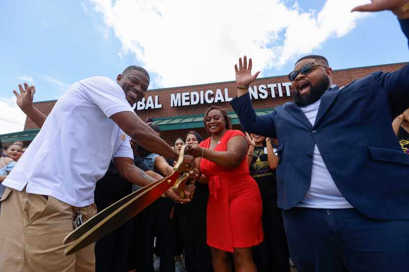 Founder Antoria Gillon, center, cuts the ribbon with husband Gabriel Evans, left, as...