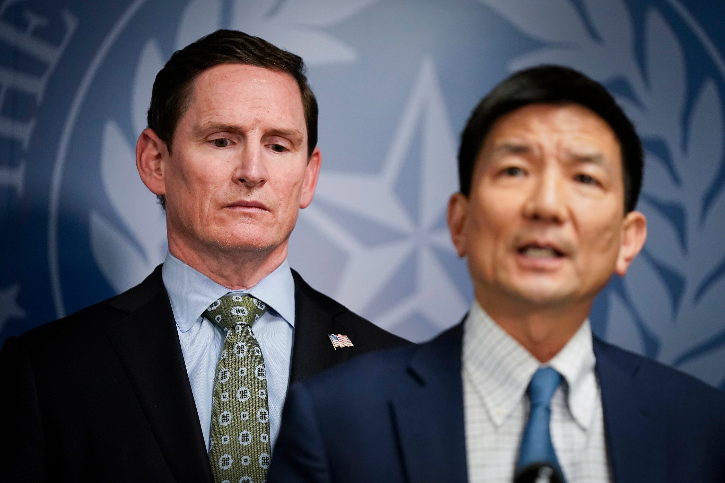 Dallas County Judge Clay Jenkins (left) listens as Dr. Philip Huang, Director of Dallas...