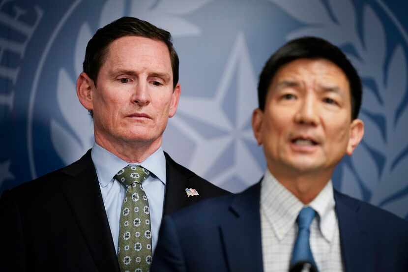 Dallas County Judge Clay Jenkins (left) listens as Dr. Philip Huang, Director of Dallas...