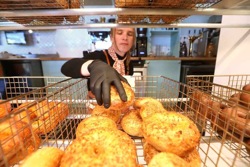 Margot Stacy grabs a garlic bagel at Lubbies Bagels in Dallas.