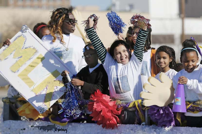 
Children cheered during Saturday’s parade in Dallas honoring the Rev. Martin Luther King...