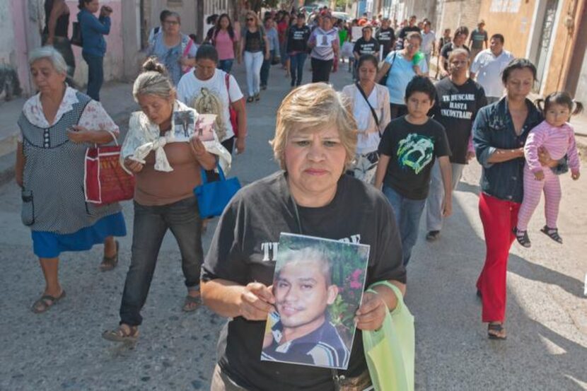 
A group marched earlier this month from a church to a meeting in Iguala with officials....