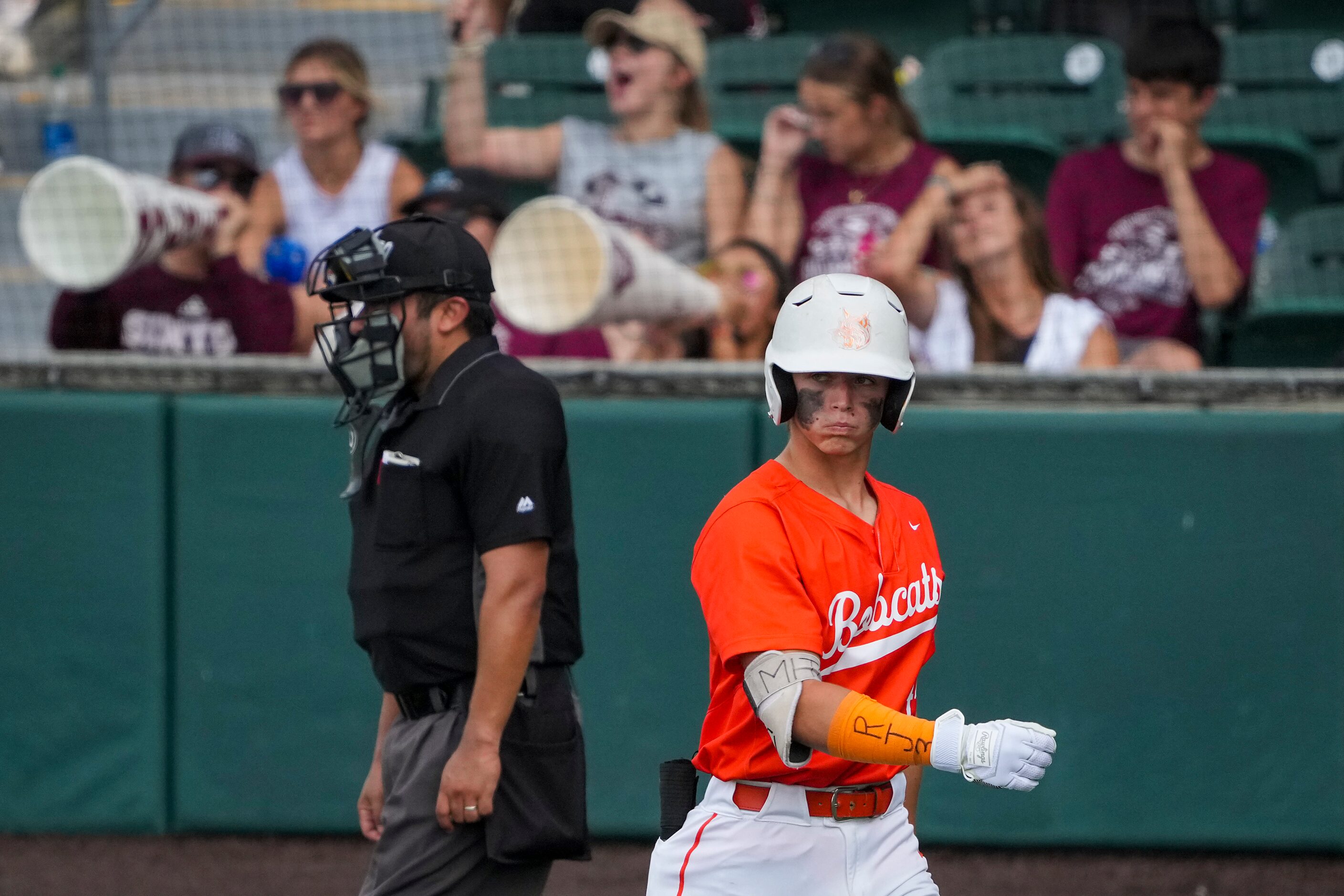 Celina designated hitter Caden Mitchell heads to the dugout after striking out during the...