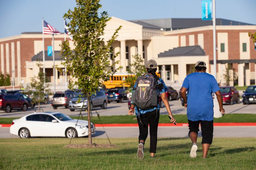 A mother walked her daughter to class at Rock Hill High School in Frisco on Wednesday for...