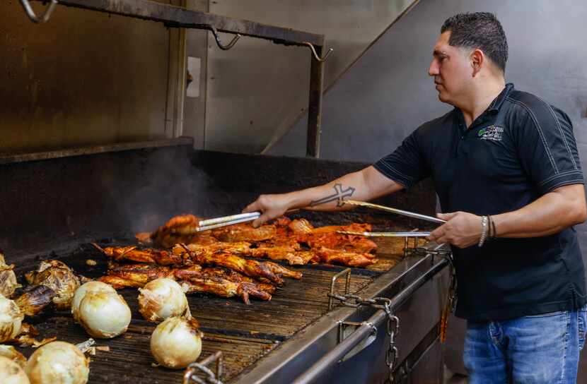 Alex Farfan cooks chicken in the kitchen of Catrina Grill, a restaurant in Lewisville, on...