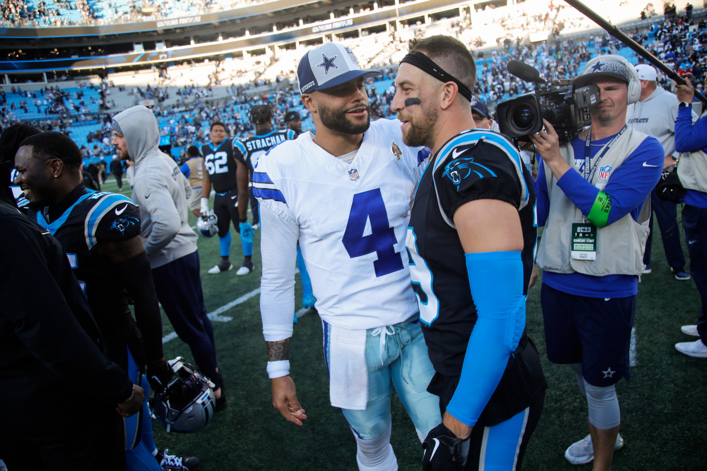 Dallas Cowboys quarterback Dak Prescott (4) chats with Carolina Panthers wide receiver Adam...