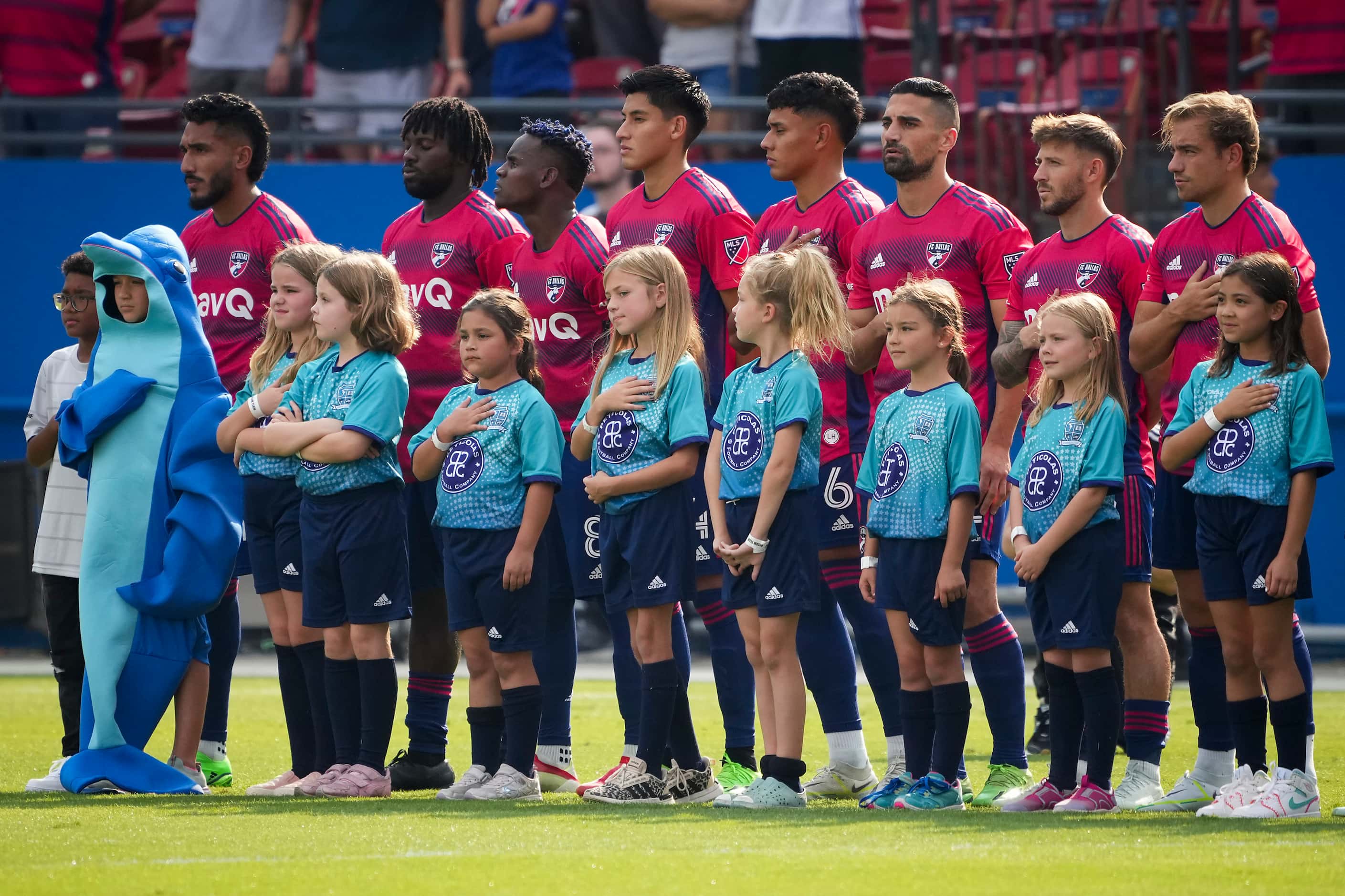 FC Dallas players stand for the national anthem before an MLS soccer match against Sporting...