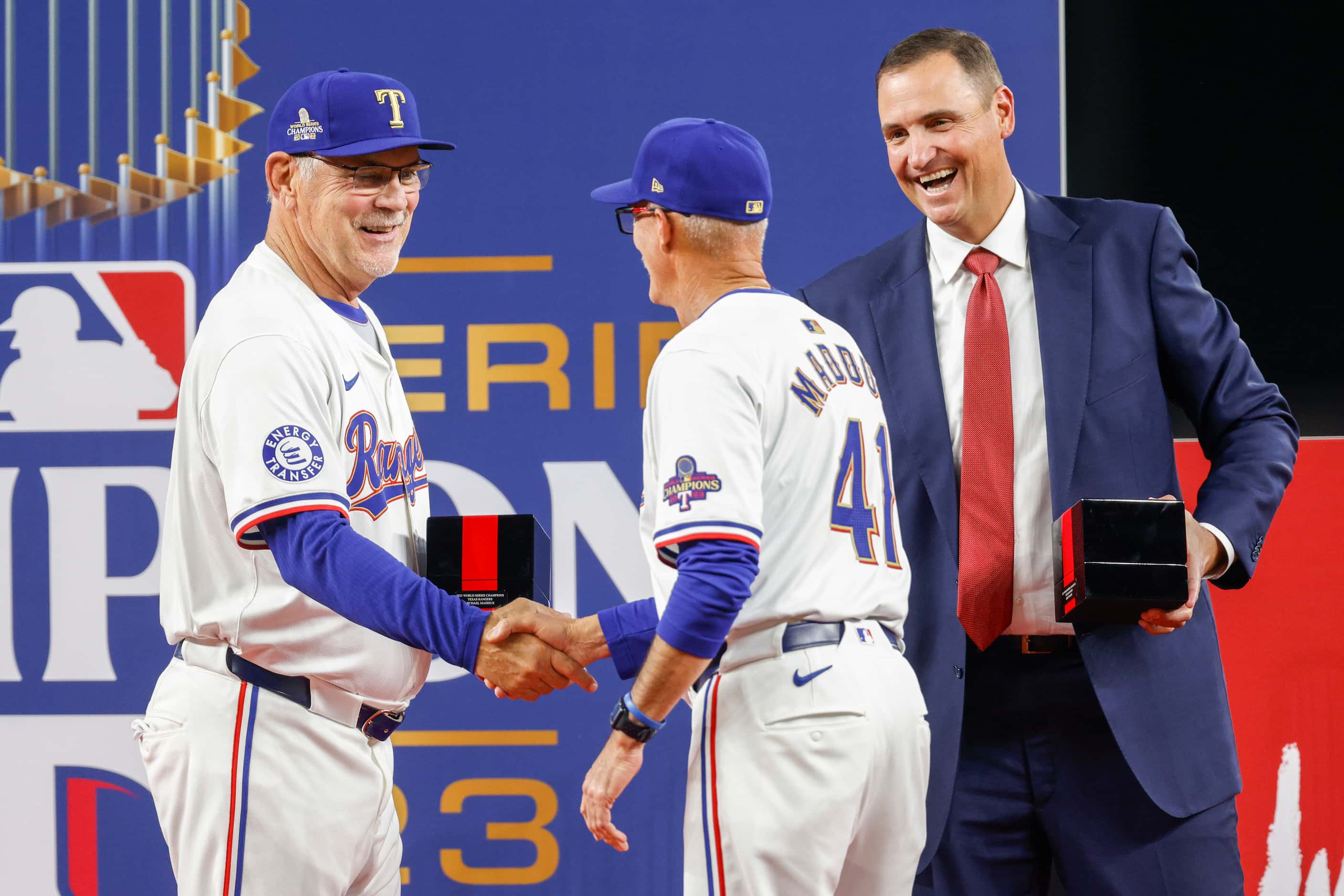 Texas Rangers manager Bruce Bochy shakes hands with pitching coach Mike Maddux as he...