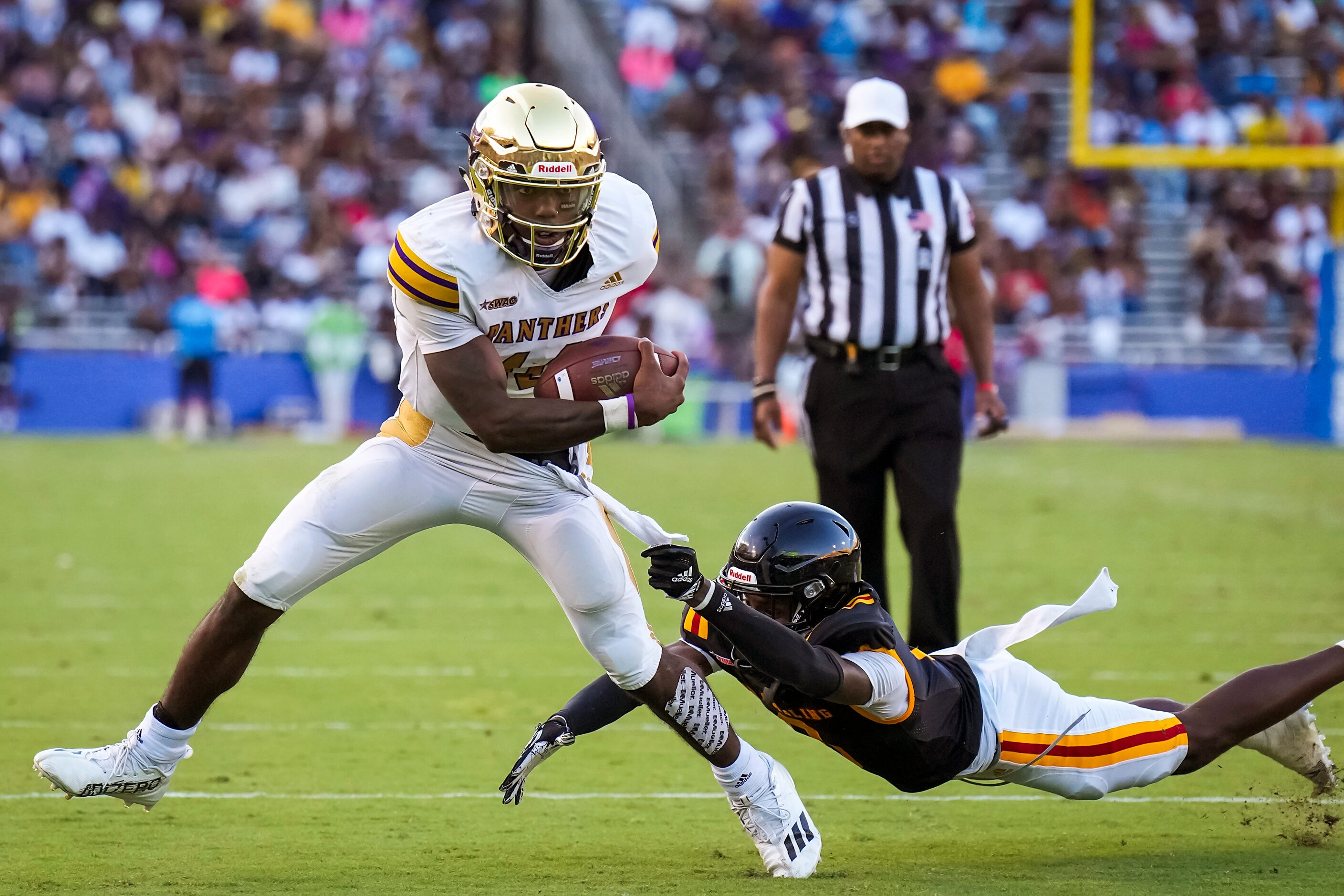 Prairie View quarterback Trazon Connley (14) gets past Grambling defensive back Reyondous...