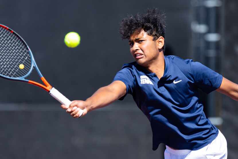 Frisco Centennial’s Rahul Muppavarapu returns a shot during a doubles match with partner...