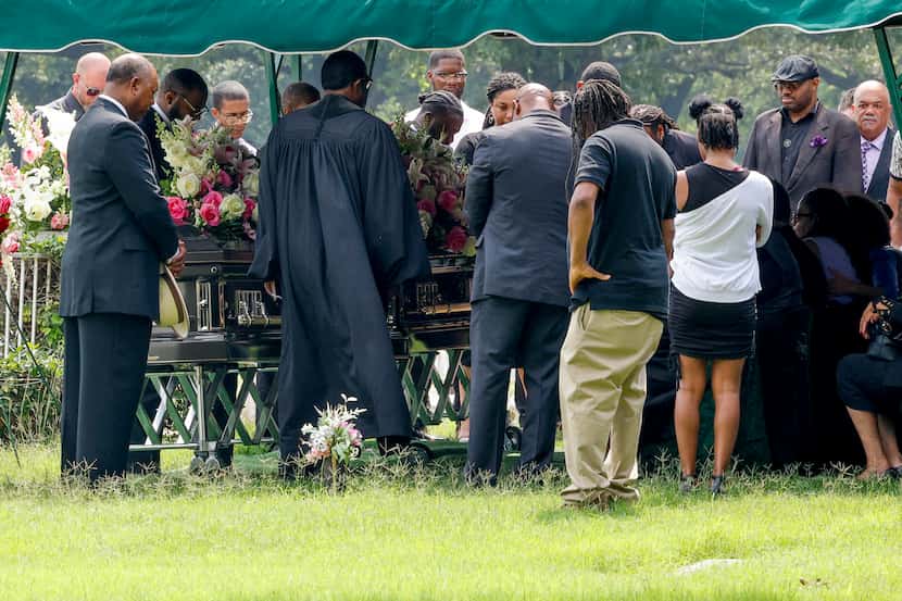 Mourners pray around the caskets of Amaya Lockett, 24, and Jalisa Lockett, 22, at Laurel...