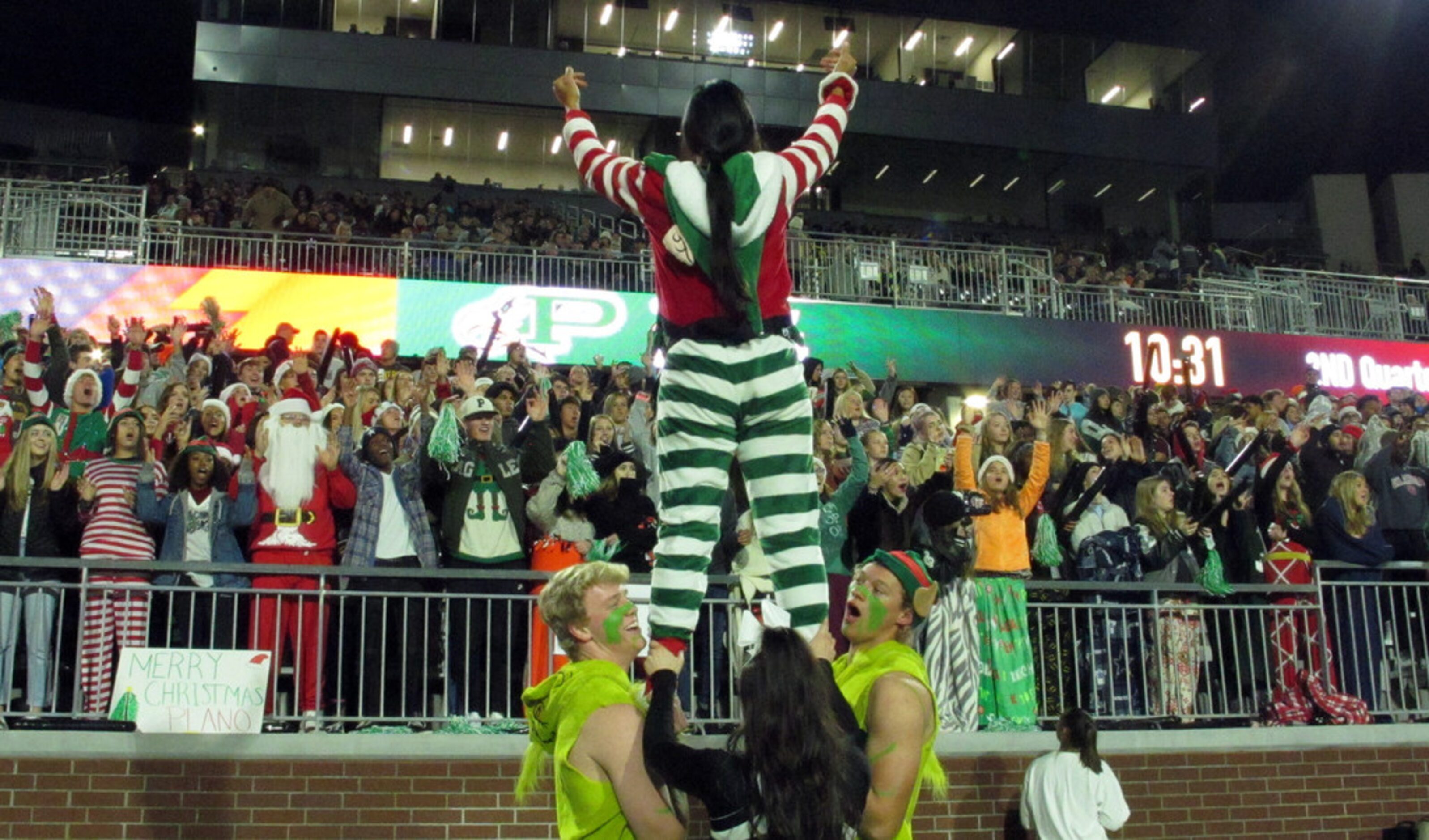 Fans cheer in the first half of a high school football game between Plano and Prosper, in...