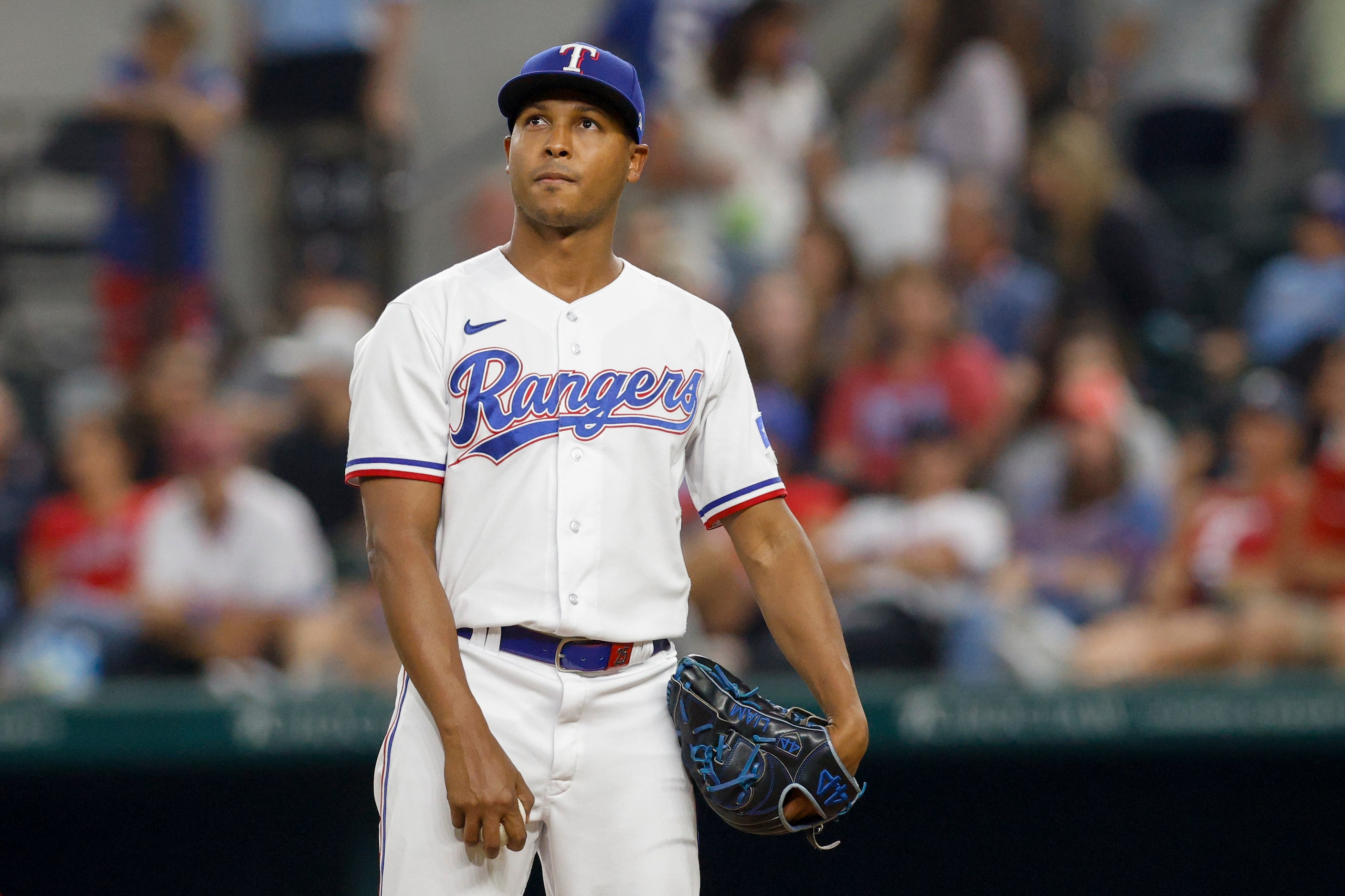 Texas Rangers relief pitcher Jose Leclerc (25) watches a replay after giving up a home run...