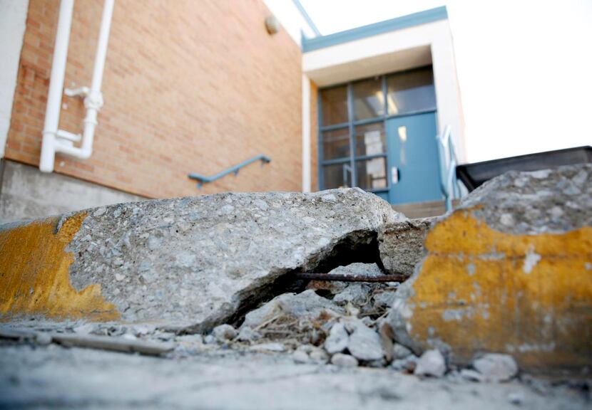 
At Edison Middle Learning Center, the pathway to the school bus dock is broken. Under the...