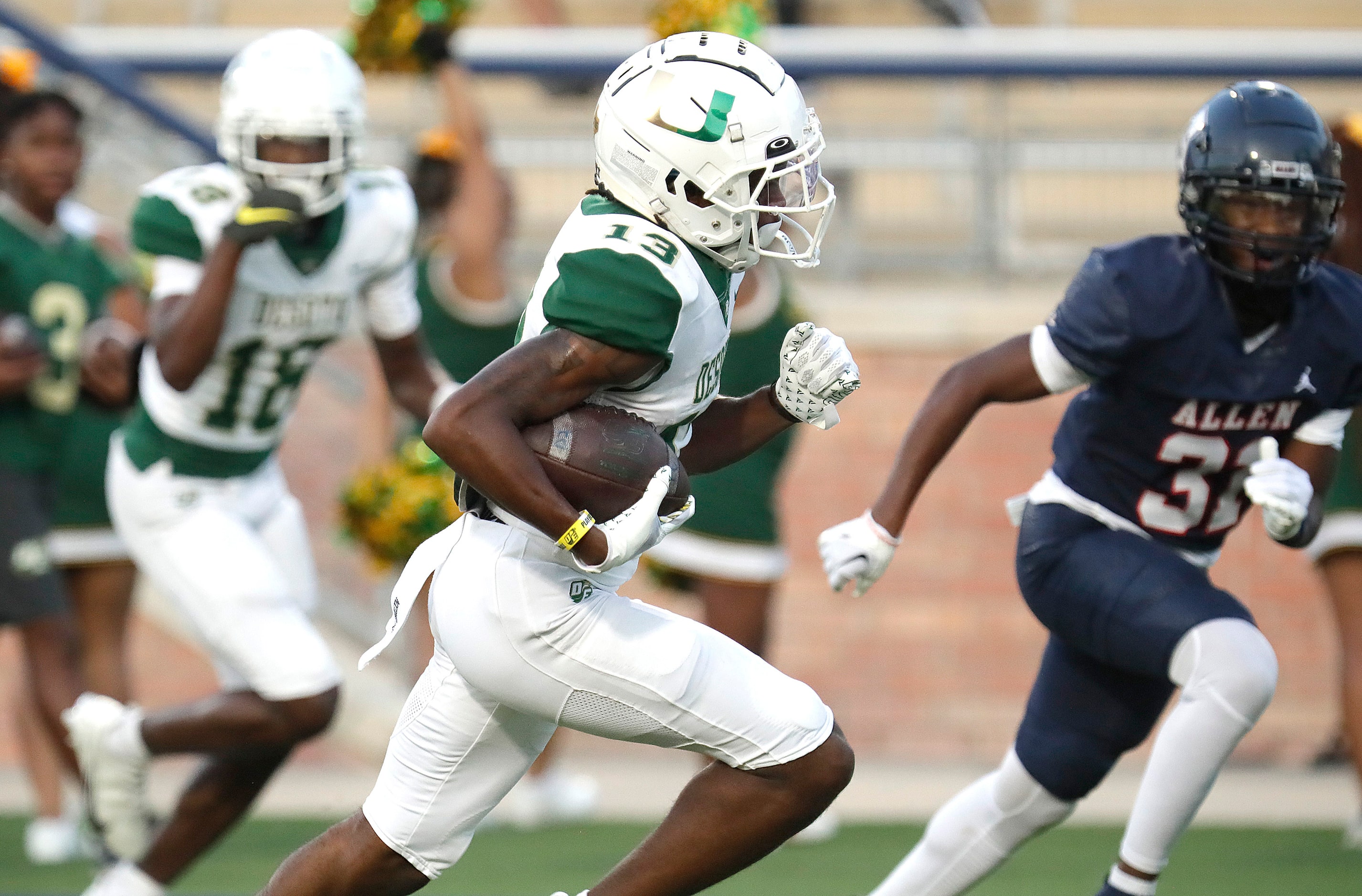 DeSoto High School wide receiver Daylon Singleton (13) heads to the end zone after the catch...