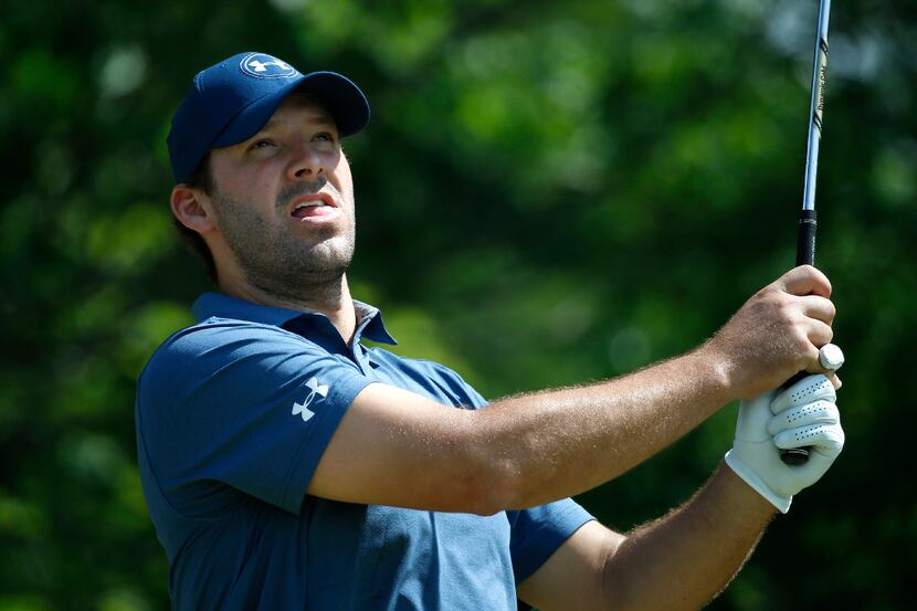 Former Dallas Cowboys quarterback Tony Romo watches his tee shot on the 8th tee box during...