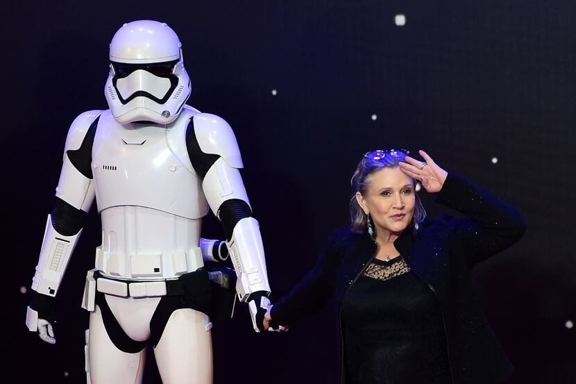 This file photo taken on December 16, 2015 shows US actress Carrie Fisher (R) posing with a...