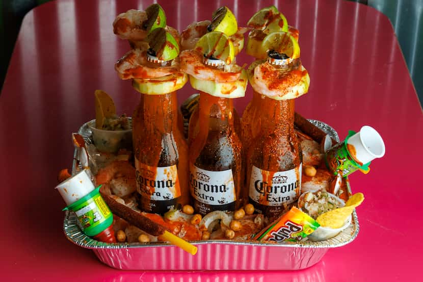 A michelada tray, $55, comes with six beers, shrimp, cucumber and tamarind candies at the...