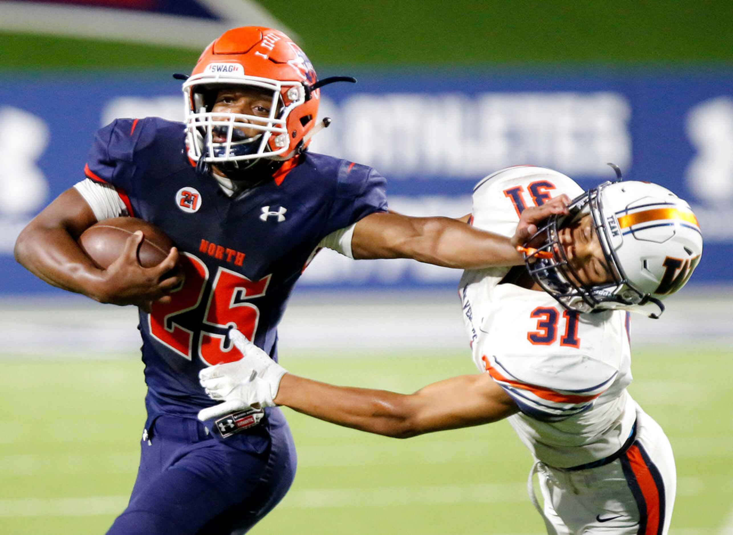 McKinney North High School running back Jayden Smith (25) stiff arms Wakeland High School...