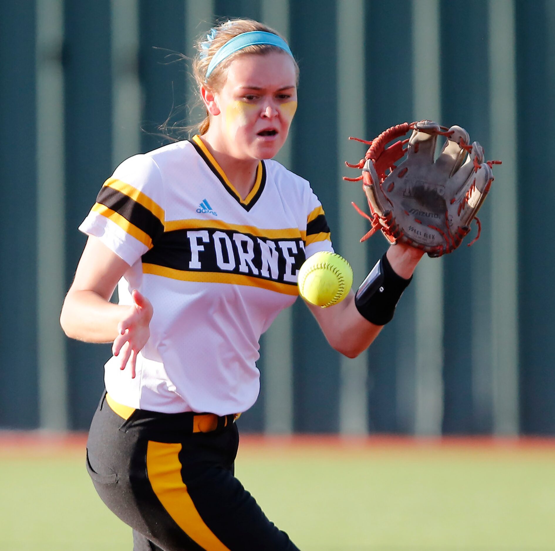 Forney High School shortstop Caleigh Cross (23) fields a high bouncing grounder in the first...