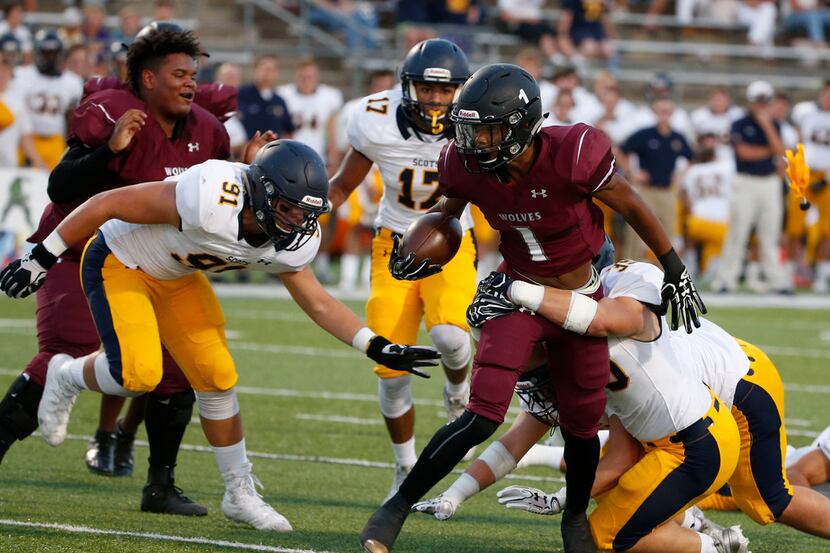Mansfield Timberview's Stacy Snead (#1)  is tackled by Highland Park's Noble Nash (39)...