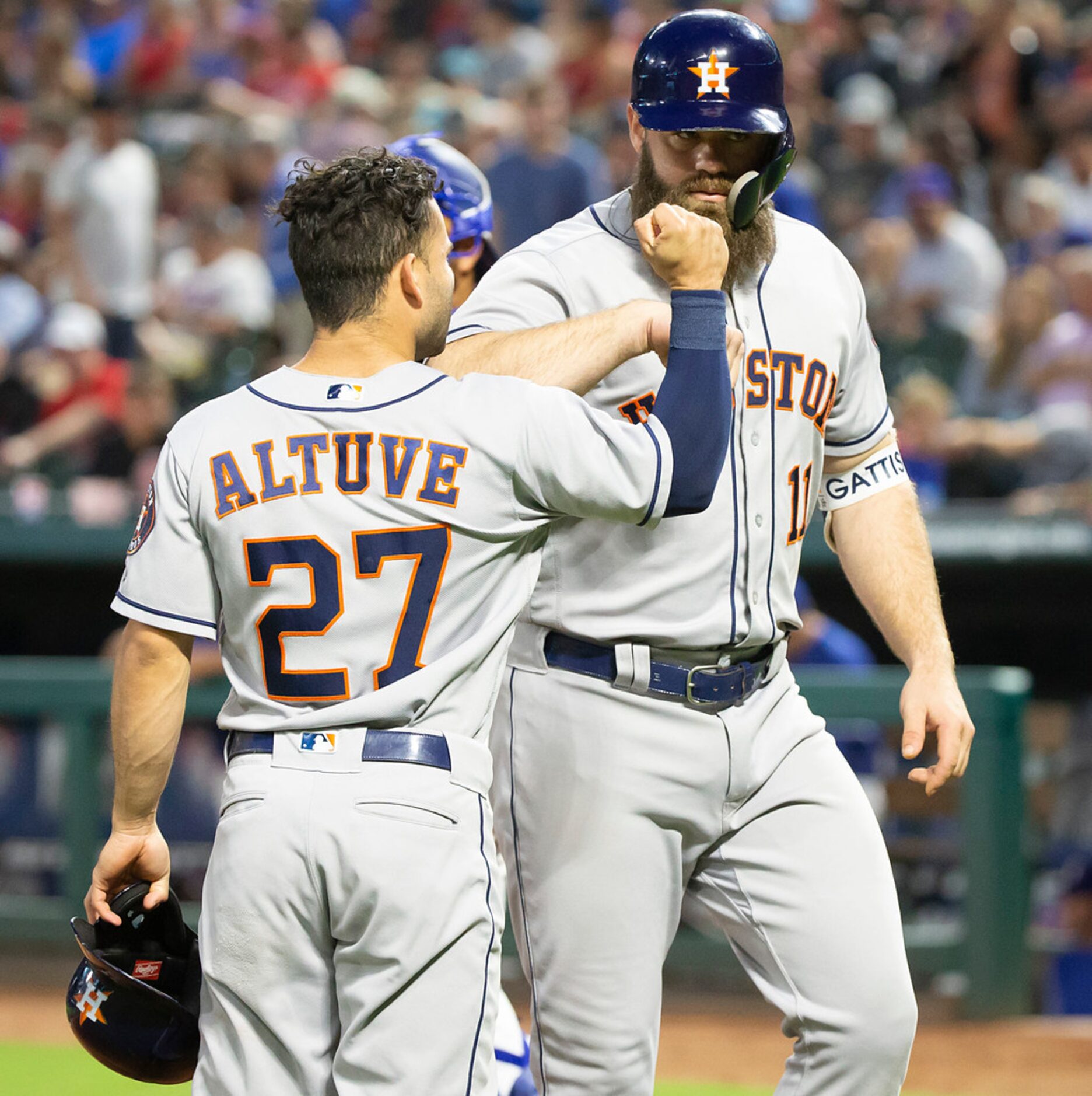 Houston Astros designated hitter Evan Gattis celebrates with second baseman Jose Altuve...