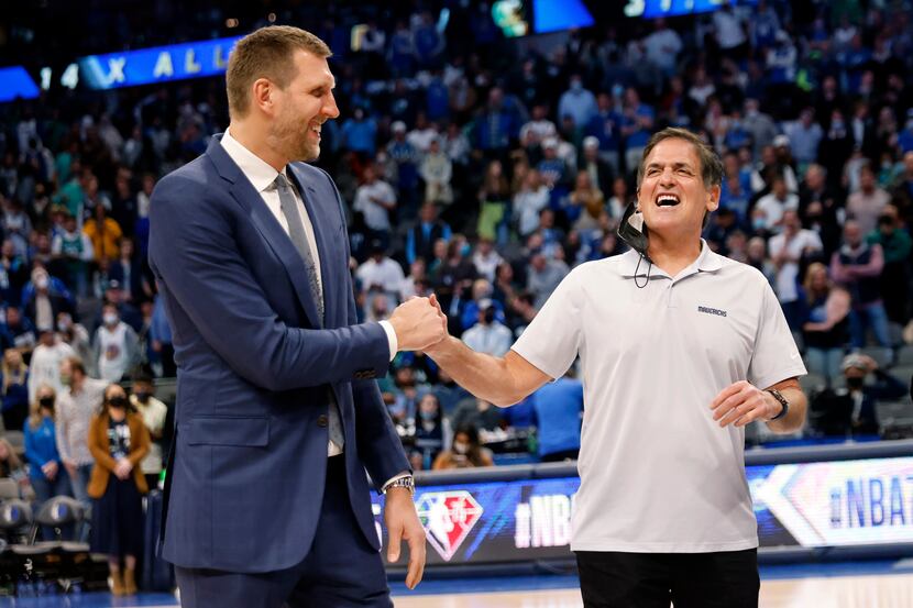 Former Dallas Mavericks All-Star Dirk Nowitzki (left) receives a fist bump from owner Mark...
