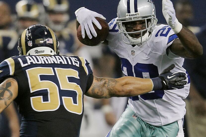 Dallas Cowboys running back DeMarco Murray (29) is defended by St. Louis Rams linebacker...