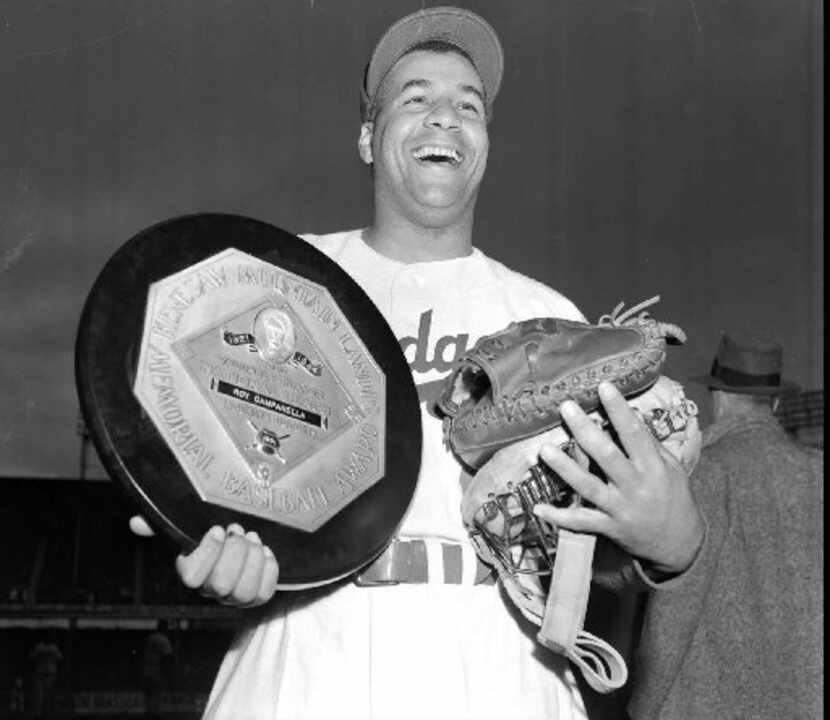 ORG XMIT: NY43 FILE--Brooklyn Dodgers catcher Roy Campanella holds his playing gear and his...