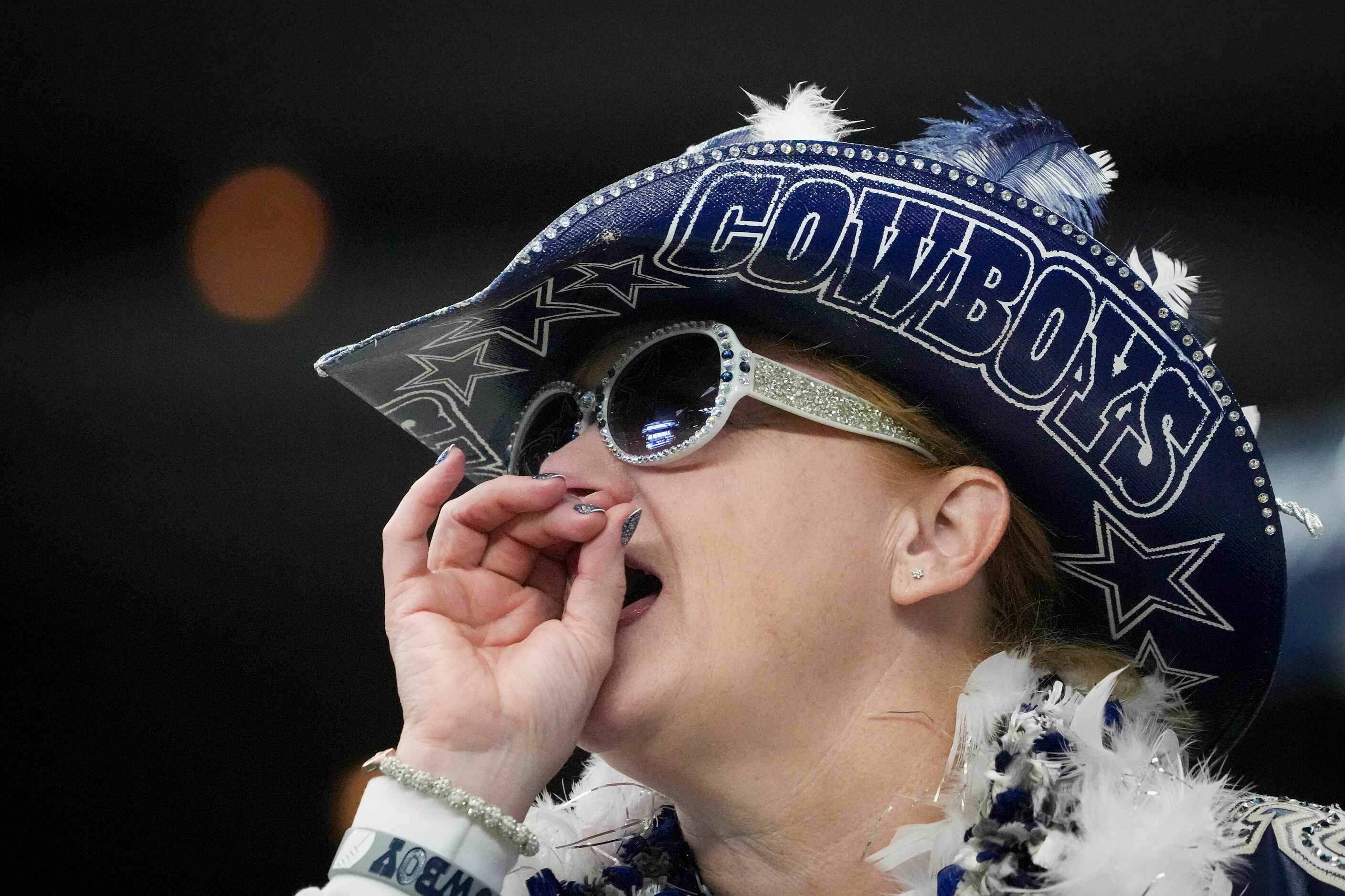 A Dallas Cowboys fan cheers during the first half of an NFL football game against the...