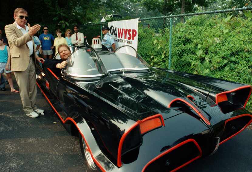 FILE - In this June 27, 1989 file photo, Adam West, left, stands beside the old Batmobile...