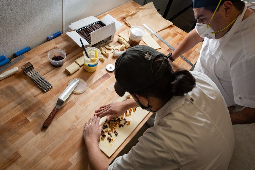 Head baker David Madrid watches Yonathan Bustillo prepare pastries at The Village in Dallas.