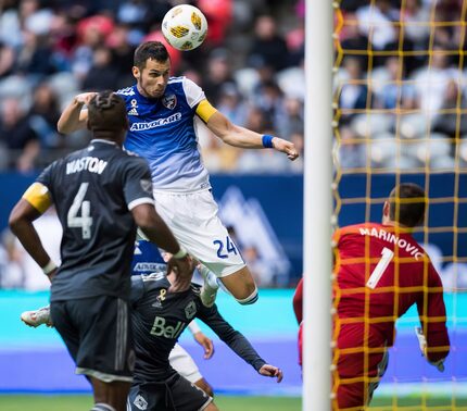 FC Dallas' Matt Hedges (24) scores the winning goal against Vancouver Whitecaps goalkeeper...