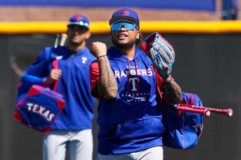 Texas Rangers outfielder Willie Calhoun takes the field for a spring training workout at the...